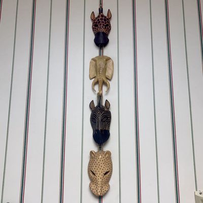 Sale Photo Thumbnail #121: A Set of Four Hand-Carved and Painted Wood African Animal Masks on a Vertical Hanging Cord