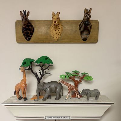 Sale Photo Thumbnail #123: A Collection of Safari Themed Decor and Plastic Animal Figures including a Wall Plaque and Display Shelf