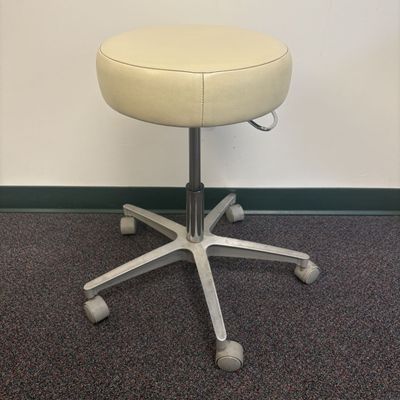 Sale Photo Thumbnail #175: Adjustable Rolling Industrial Stool with Cream Vinyl Upholstery
