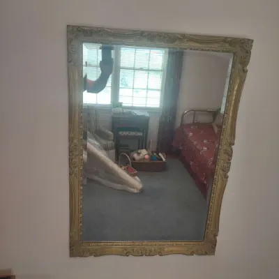 Ornately Framed Beveled Glass Mirror.