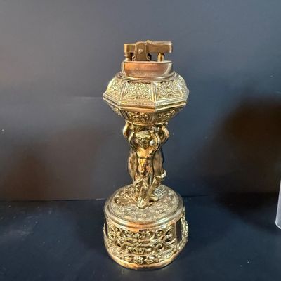 LOT 251: Collection of Desk Lighters Featuring an Antique Cherub Music Box Ligher and More