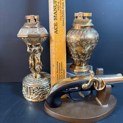 LOT 251: Collection of Desk Lighters Featuring an Antique Cherub Music Box Ligher and More