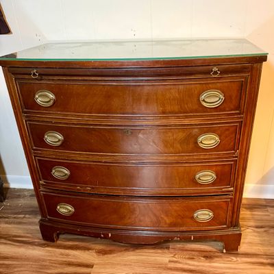 LOT 182: Bowed Front Chest of Drawers with Pull-Out Slide and Oval Hardware and Removable Glass Top