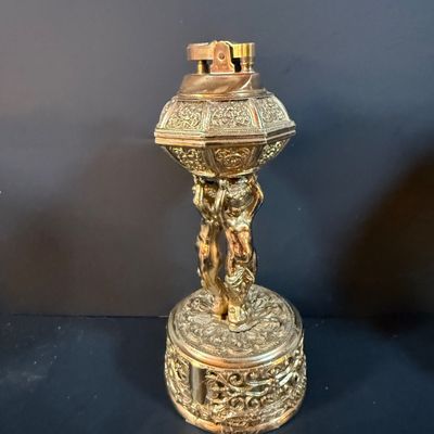 LOT 251: Collection of Desk Lighters Featuring an Antique Cherub Music Box Ligher and More