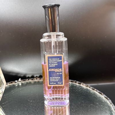LOT 254: Mirrored Vanity Tray with Perfume Bottles Including Jordache Perfume by Armani and Guerlain Baccarat Bottle and More