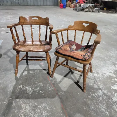 Two vintage wooden colonial-style captain's armchairs