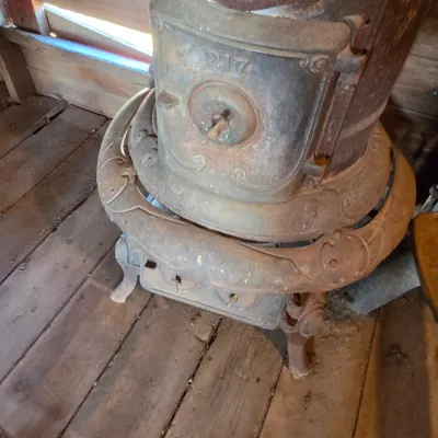 Antique cast-iron "oak-style" pot-belly stove, which reads "BONNY OAK" on the upper front door - appears complete and...