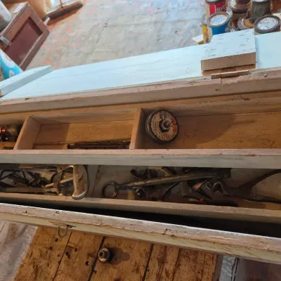 Vintage wood crate toolbox with drawer and an assortment of old tools