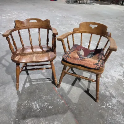 Two vintage wooden colonial-style captain's armchairs