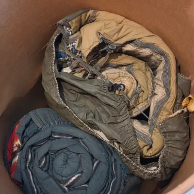 Sealed storage container with 4 sleeping bags - Military down and 2 air mattresses