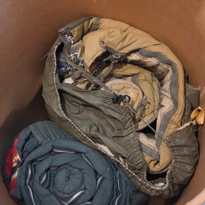 Sealed storage container with 4 sleeping bags - Military down and 2 air mattresses