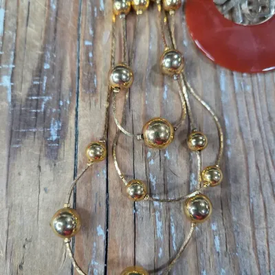 Good fortune necklace with 3 strand gold toned beaded necklace. and a pair of earrings