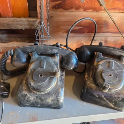 Two Leich Model 901B vintage black Bakelite desk telephones with a hand crank, 1930s or 1940s