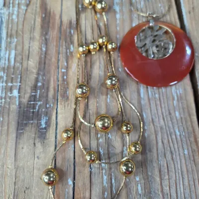 Good fortune necklace with 3 strand gold toned beaded necklace. and a pair of earrings