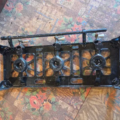 Vintage cast-iron three-burner camp stove with porcelain handles marked 137 on bottom Possibly a Griswold?