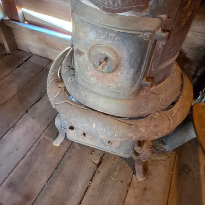 Antique cast-iron "oak-style" pot-belly stove, which reads "BONNY OAK" on the upper front door - appears complete and...