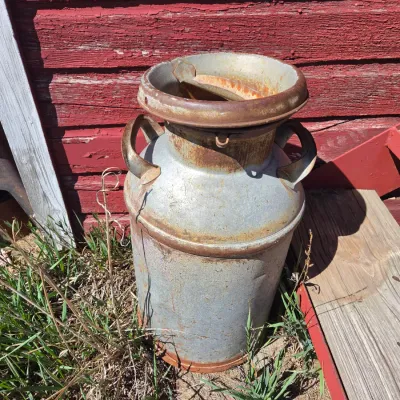 Two vintage & rustic milk cans