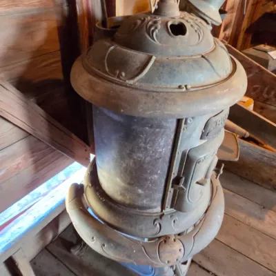 Antique cast-iron "oak-style" pot-belly stove, which reads "BONNY OAK" on the upper front door - appears complete and...