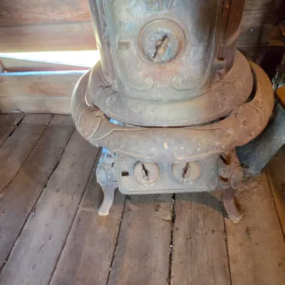 Antique cast-iron "oak-style" pot-belly stove, which reads "BONNY OAK" on the upper front door - appears complete and...