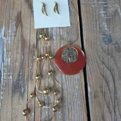 Good fortune necklace with 3 strand gold toned beaded necklace. and a pair of earrings