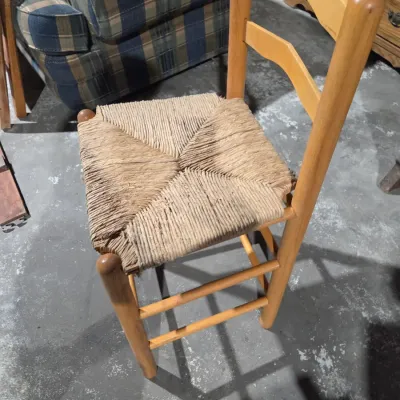 Vintage light wood ladder-back chair with a traditional woven rush seat