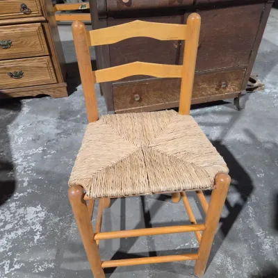 Vintage light wood ladder-back chair with a traditional woven rush seat