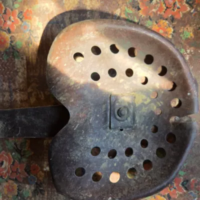 Two rustic tractor seats with seat attachment