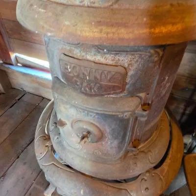 Antique cast-iron "oak-style" pot-belly stove, which reads "BONNY OAK" on the upper front door - appears complete and...