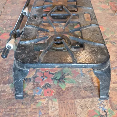 Vintage cast-iron three-burner camp stove with porcelain handles marked 137 on bottom Possibly a Griswold?