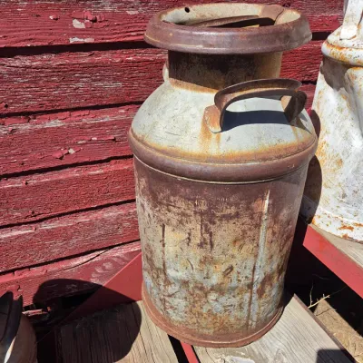 Two vintage & rustic milk cans