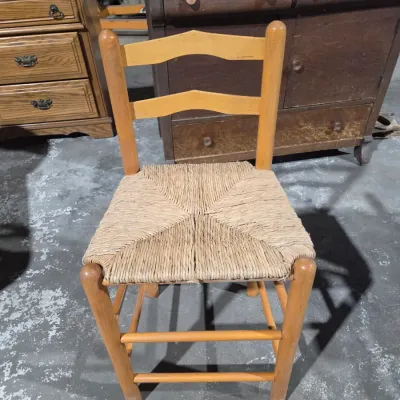 Vintage light wood ladder-back chair with a traditional woven rush seat