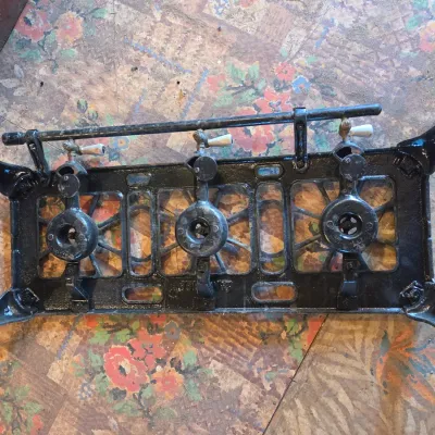 Vintage cast-iron three-burner camp stove with porcelain handles marked 137 on bottom Possibly a Griswold?