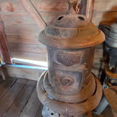 Antique cast-iron "oak-style" pot-belly stove, which reads "BONNY OAK" on the upper front door - appears complete and...