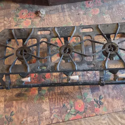 Vintage cast-iron three-burner camp stove with porcelain handles marked 137 on bottom Possibly a Griswold?