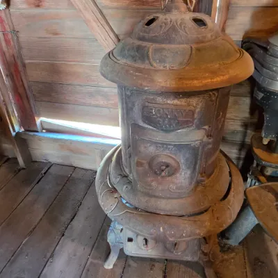 Antique cast-iron "oak-style" pot-belly stove, which reads "BONNY OAK" on the upper front door - appears complete and...