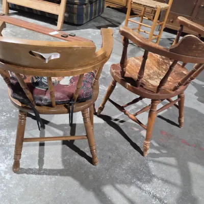 Two vintage wooden colonial-style captain's armchairs