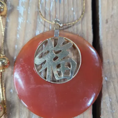Good fortune necklace with 3 strand gold toned beaded necklace. and a pair of earrings
