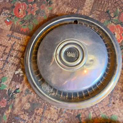 Three vintage chrome hubcaps