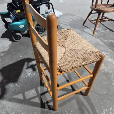 Vintage light wood ladder-back chair with a traditional woven rush seat