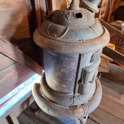 Antique cast-iron "oak-style" pot-belly stove, which reads "BONNY OAK" on the upper front door - appears complete and...