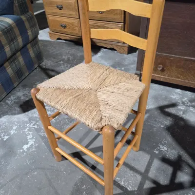 Vintage light wood ladder-back chair with a traditional woven rush seat