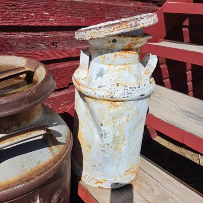 Two vintage & rustic milk cans