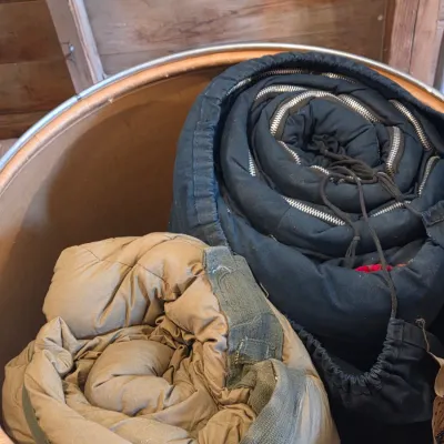 Sealed storage container with 4 sleeping bags - Military down and 2 air mattresses