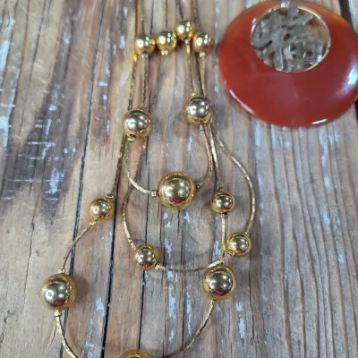 Good fortune necklace with 3 strand gold toned beaded necklace. and a pair of earrings