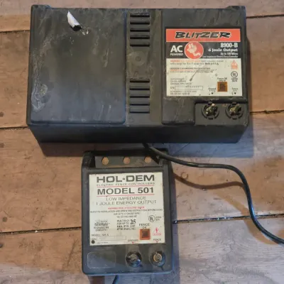 Two electric fence chargers - Blitzer 8900-B and a Hol-Dem model 501