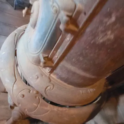 Antique cast-iron "oak-style" pot-belly stove, which reads "BONNY OAK" on the upper front door - appears complete and...