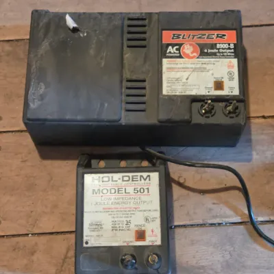 Two electric fence chargers - Blitzer 8900-B and a Hol-Dem model 501