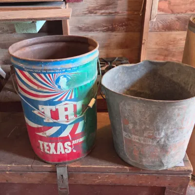 Two vintage metal buckets