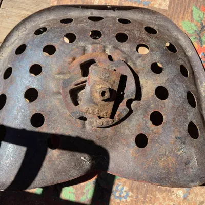 Two vintage steel tractor seats - one partially green