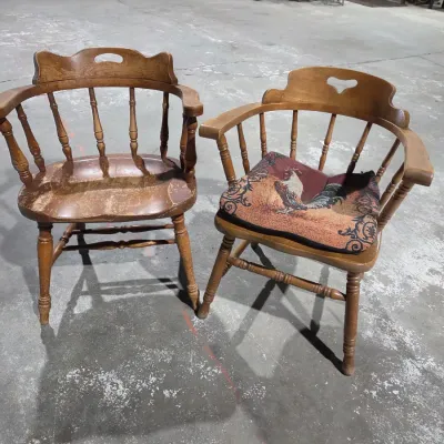 Two vintage wooden colonial-style captain's armchairs